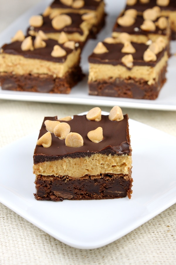 peanut butter cookie dough brownie on a white plate with more brownies in the background