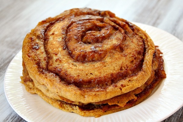 Pumpkin Cinnamon Roll Pancakes on a white plate