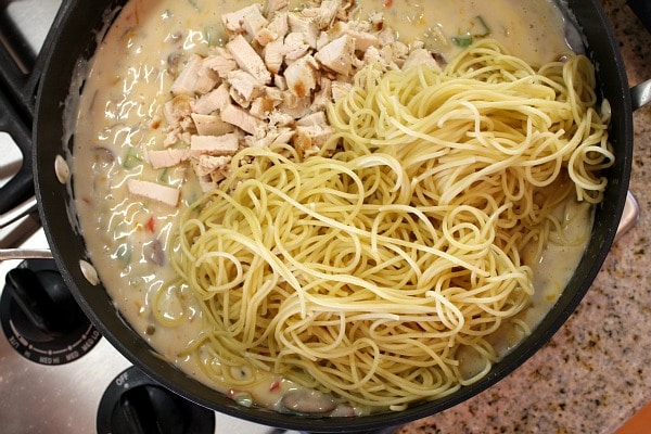 Chicken Spaghetti Casserole recipe from RecipeGirl.com #chicken #spaghetti #casserole #recipe #RecipeGirl making chicken spaghetti casserole in a skillet