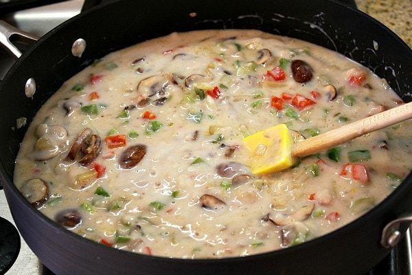 Chicken Spaghetti Casserole recipe from RecipeGirl.com #chicken #spaghetti #casserole #recipe #RecipeGirl making sauce for chicken spaghetti casserole in a skillet