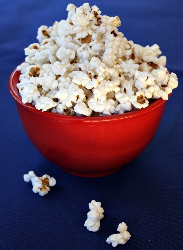 Kids cook popcorn at home in a popcorn maker Stock Photo