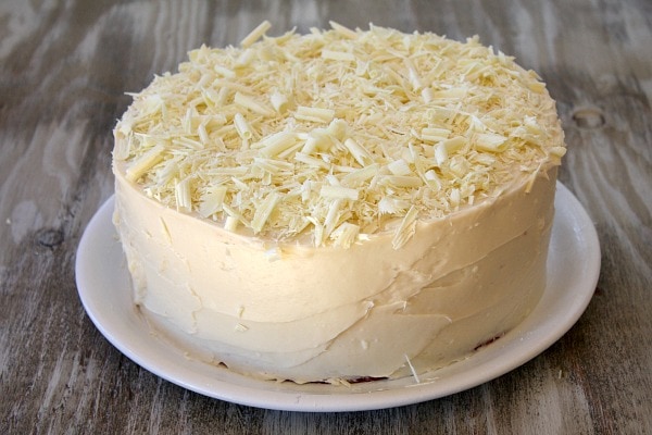 white frosted red velvet cake on a white plate