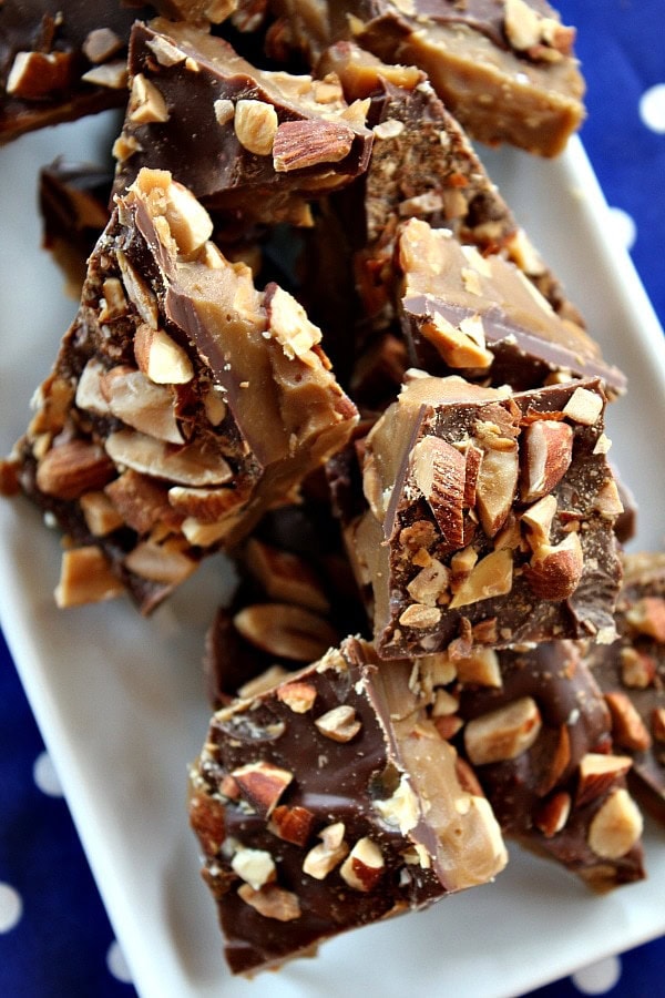 almond roca on a white plate sitting on a blue and white polka dot napkin