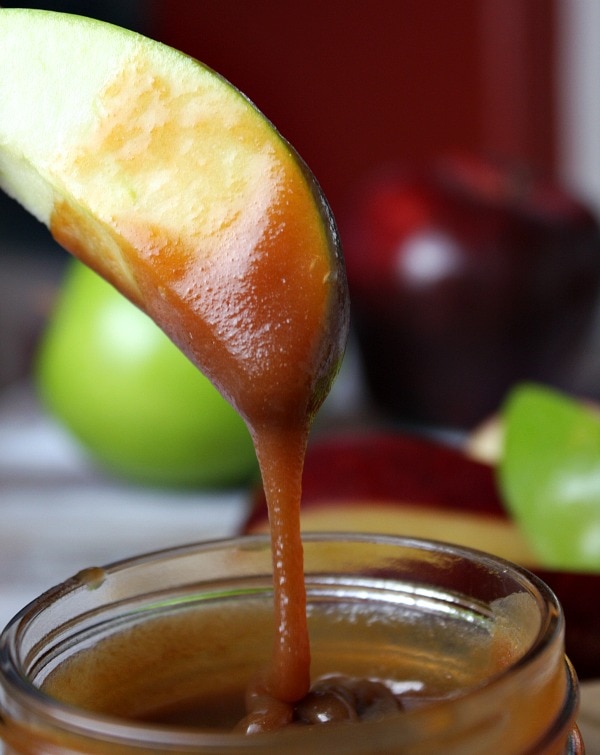 dipping apples in salted caramel sauce