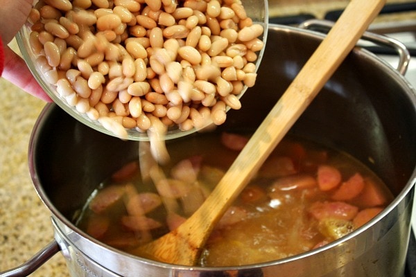 adding beans to soup