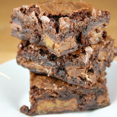 caramel brownies stacked on plate