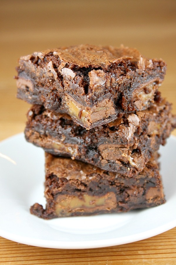 caramel brownies stacked on plate