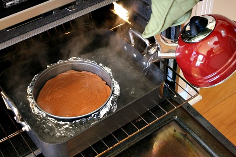 Chocolate Cheesecake Cake recipe from RecipeGirl.com #chocolate #cheesecake #cake #recipe #RecipeGirl Making a water bath for chocolate cheesecake