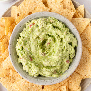 bowl of crab guacamole surrounded by tortilla chips