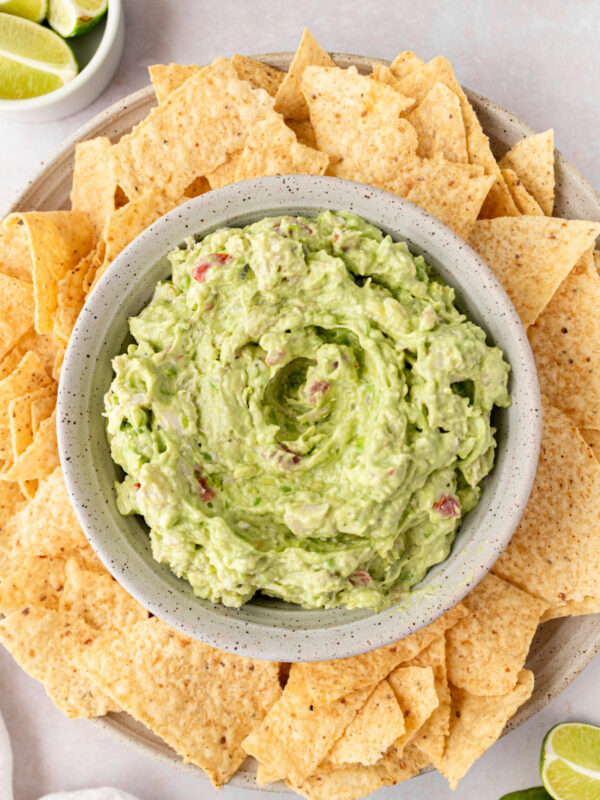 bowl of crab guacamole surrounded by tortilla chips