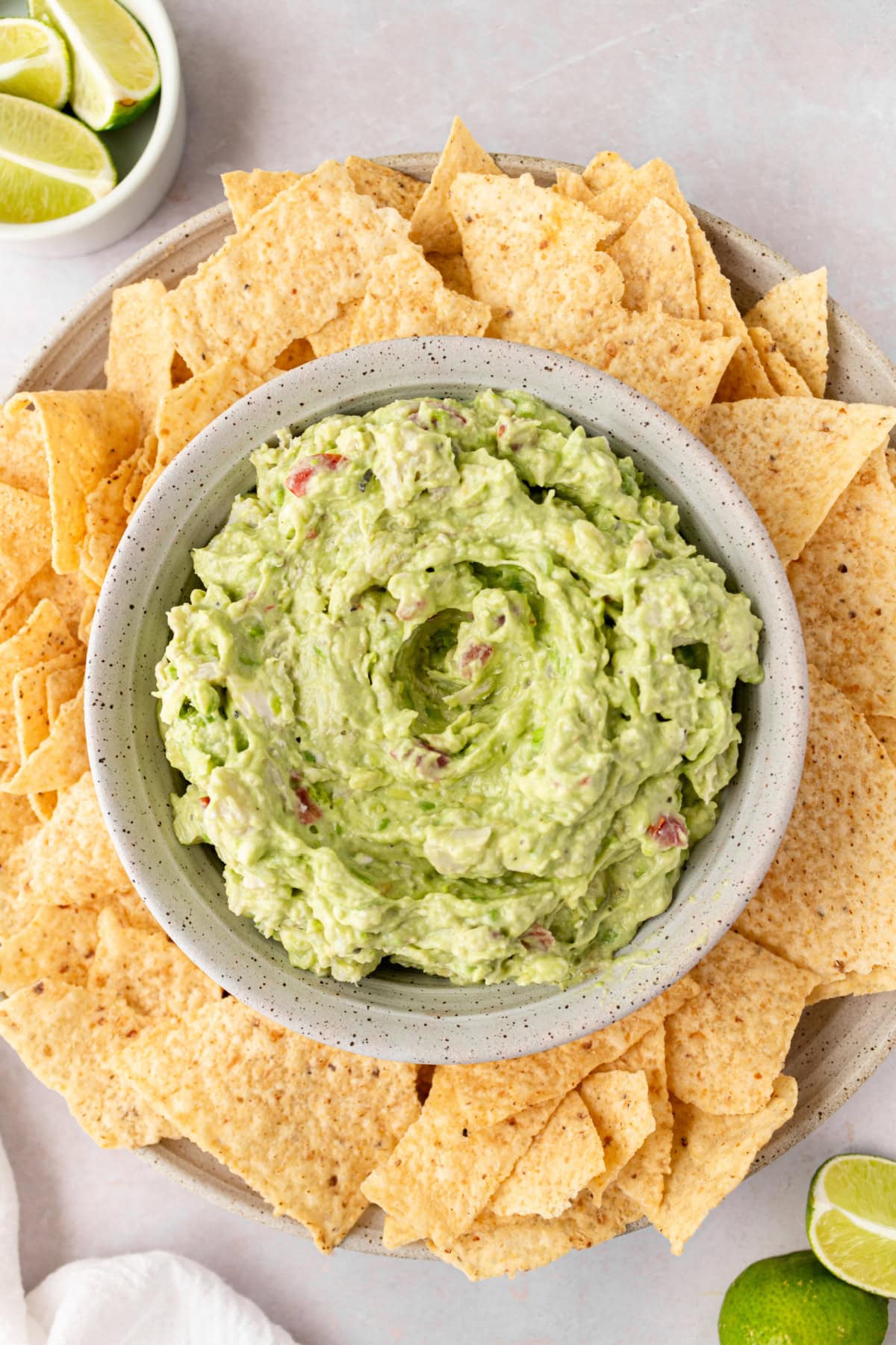 Crab Guacamole is a creamy, fresh twist on classic guacamole with avocado, crab and lime. Easy and perfect for entertaining! bowl of crab guacamole surrounded by tortilla chips