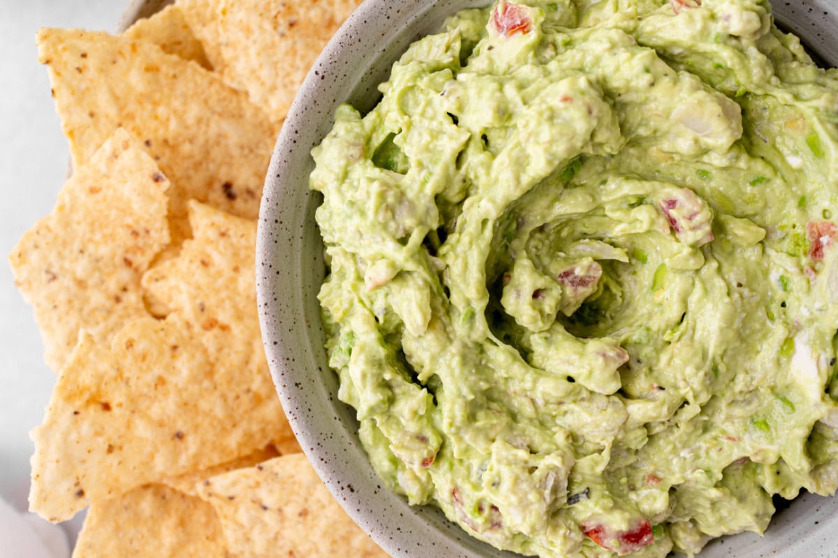 Crab Guacamole is a creamy, fresh twist on classic guacamole with avocado, crab and lime. Easy and perfect for entertaining! close up crab guacamole and chips