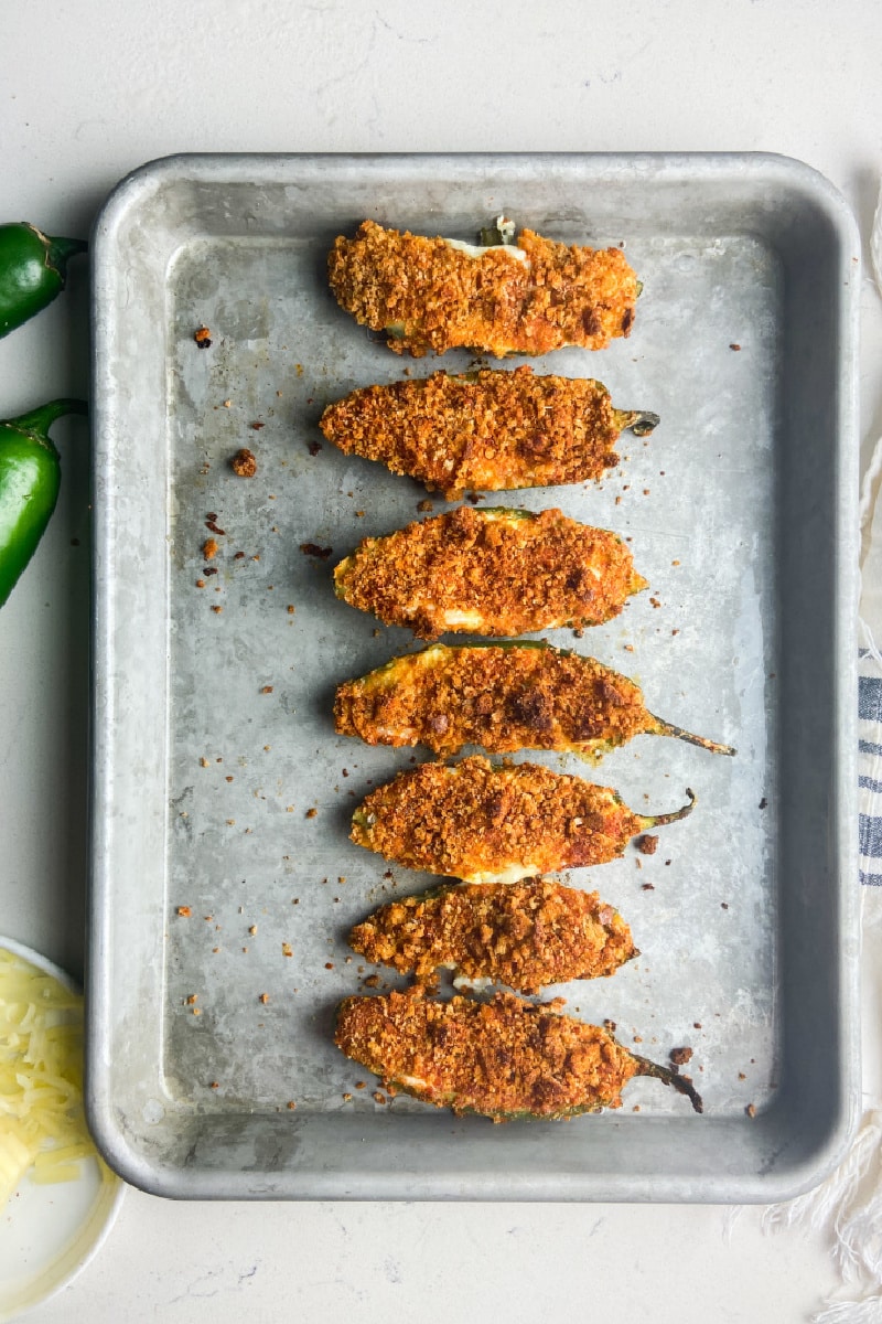 baked jalapeno poppers on baking sheet