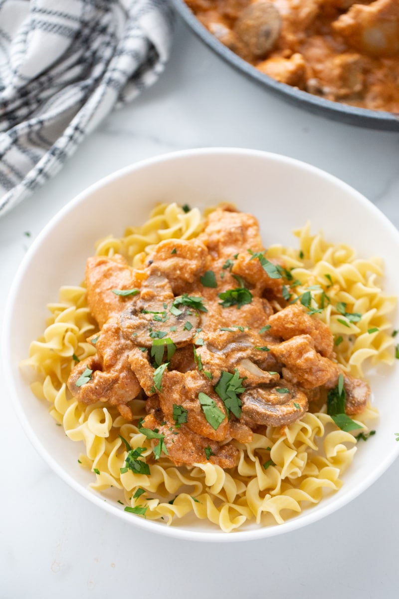 bowl of chicken stroganoff over egg noodles