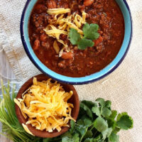 Halftime Chili in a bowl with cheese and cilantro