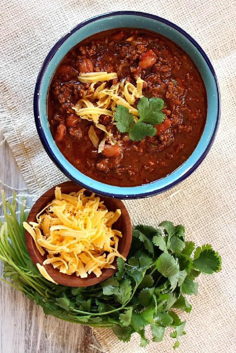 Halftime Chili in a bowl with cheese and cilantro
