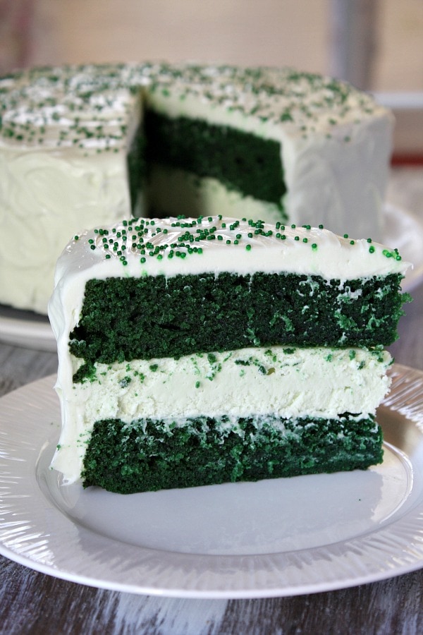 Green Velvet Cheesecake Cake recipe from RecipeGirl.com : two layers of green velvet cake with cheesecake in the middle #green #velvet #cheesecake #cake #recipe #StPatricksday #RecipeGirl Slice of Green Velvet Cheesecake Cake
