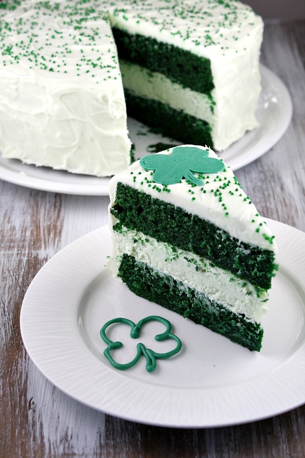 Green Velvet Cheesecake Cake recipe from RecipeGirl.com : two layers of green velvet cake with cheesecake in the middle #green #velvet #cheesecake #cake #recipe #StPatricksday #RecipeGirl Serving Green Velvet Cheesecake Cake