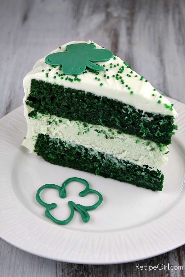 Green Velvet Cheesecake Cake recipe from RecipeGirl.com : two layers of green velvet cake with cheesecake in the middle #green #velvet #cheesecake #cake #recipe #StPatricksday #RecipeGirl Slice of Green Velvet Cheesecake Cake