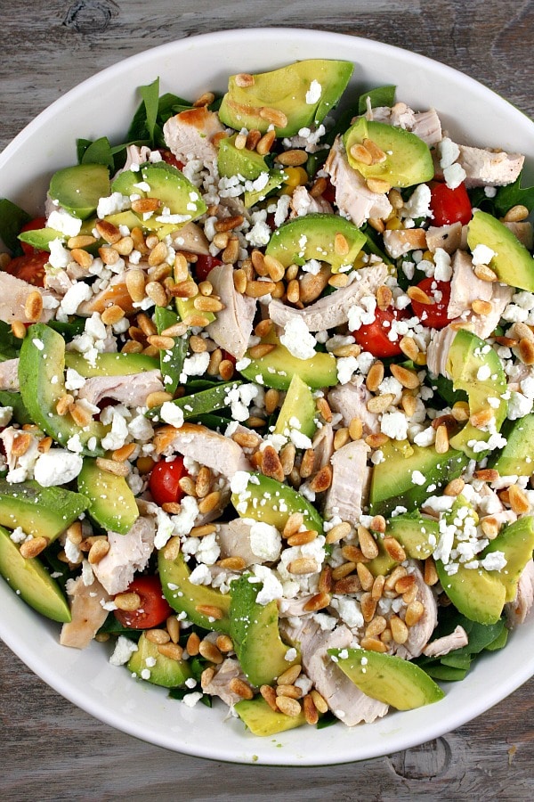 Spinach Salad with Chicken, Avocado and Goat Cheese recipe from RecipeGirl.com #spinach #salad #chicken #avocado #goat #cheese #goatcheese #recipe #RecipeGirl Spinach Salad with Chicken, Avocado and Goat Cheese in bowl