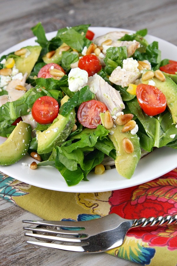 Spinach Salad with Chicken, Avocado and Goat Cheese recipe from RecipeGirl.com #spinach #salad #chicken #avocado #goat #cheese #goatcheese #recipe #RecipeGirl Spinach Salad with Chicken, Avocado and Goat Cheese serving on plate