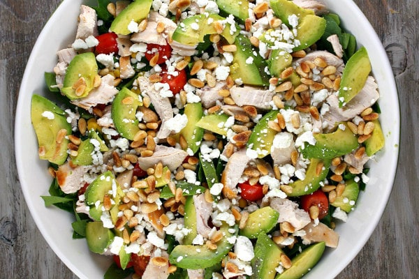 Spinach Salad with Chicken, Avocado and Goat Cheese recipe from RecipeGirl.com #spinach #salad #chicken #avocado #goat #cheese #goatcheese #recipe #RecipeGirl Spinach Salad with Chicken, Avocado and Goat Cheese in bowl