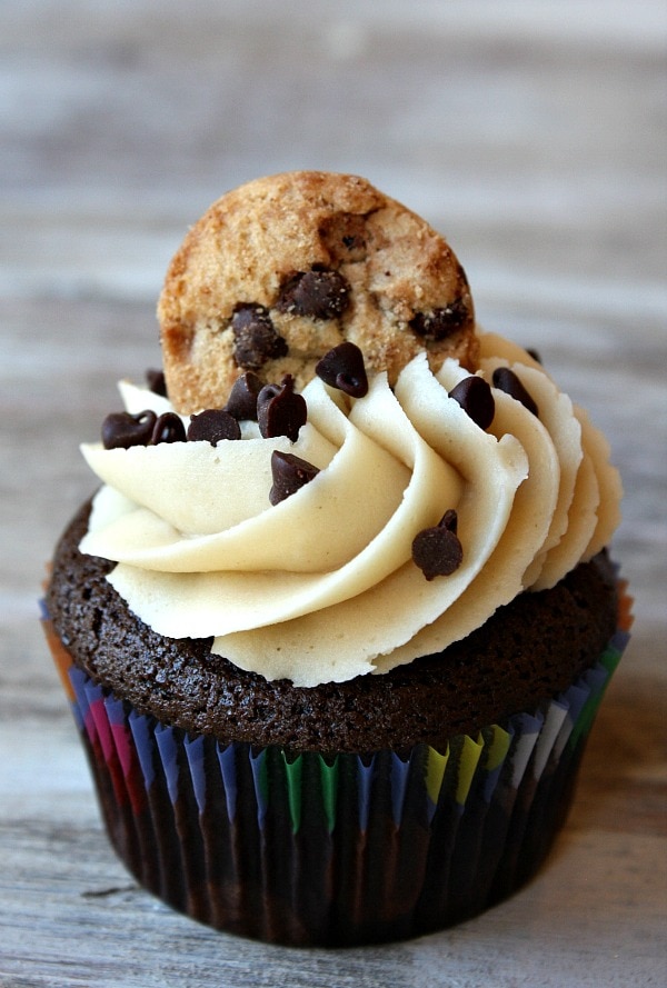 Chocolate Chip Cookie Dough Cupcakes garnished with a chocolate chip cookie