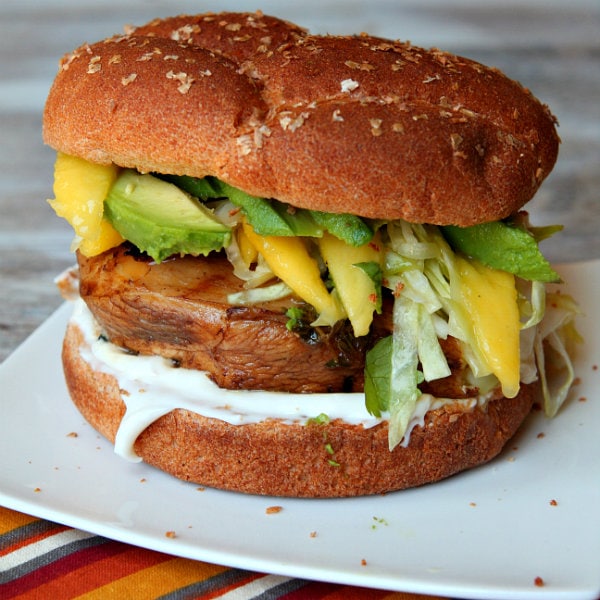 Balsamic Grilled Chicken Sandwich with Avocado and Mango Slaw Balsamic Mango Marinated Chicken Sandwich on white plate