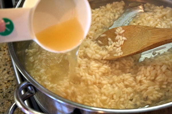 Shiitake and Sweet Pea Risotto 9 adding broth to risotto in pan
