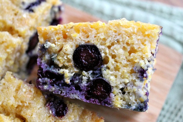 close up shot of a piece of blueberry cornbread