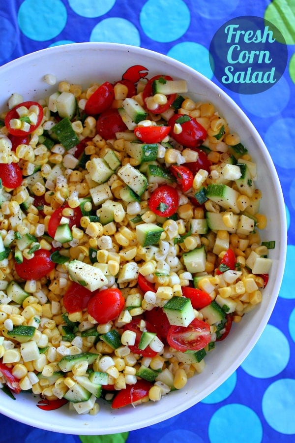 Fresh Corn, Zucchini and Tomato Salad in a white bowl set on a blue polka dot tablecloth