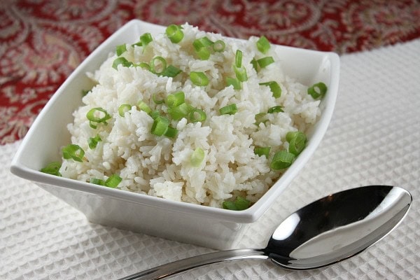 Easy Coconut Rice recipe from RecipeGirl.com #easy #coconut #rice #recipe #RecipeGirl Coconut rice in a white dish