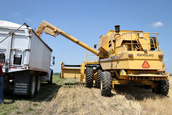 combine adding wheat to another truck