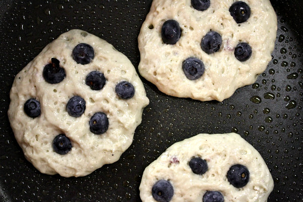 Greek Yogurt Pancakes recipe from RecipeGirl.com #Greek #yogurt #pancakes #recipe #RecipeGirl Blueberry Greek Yogurt Pancakes on the griddle