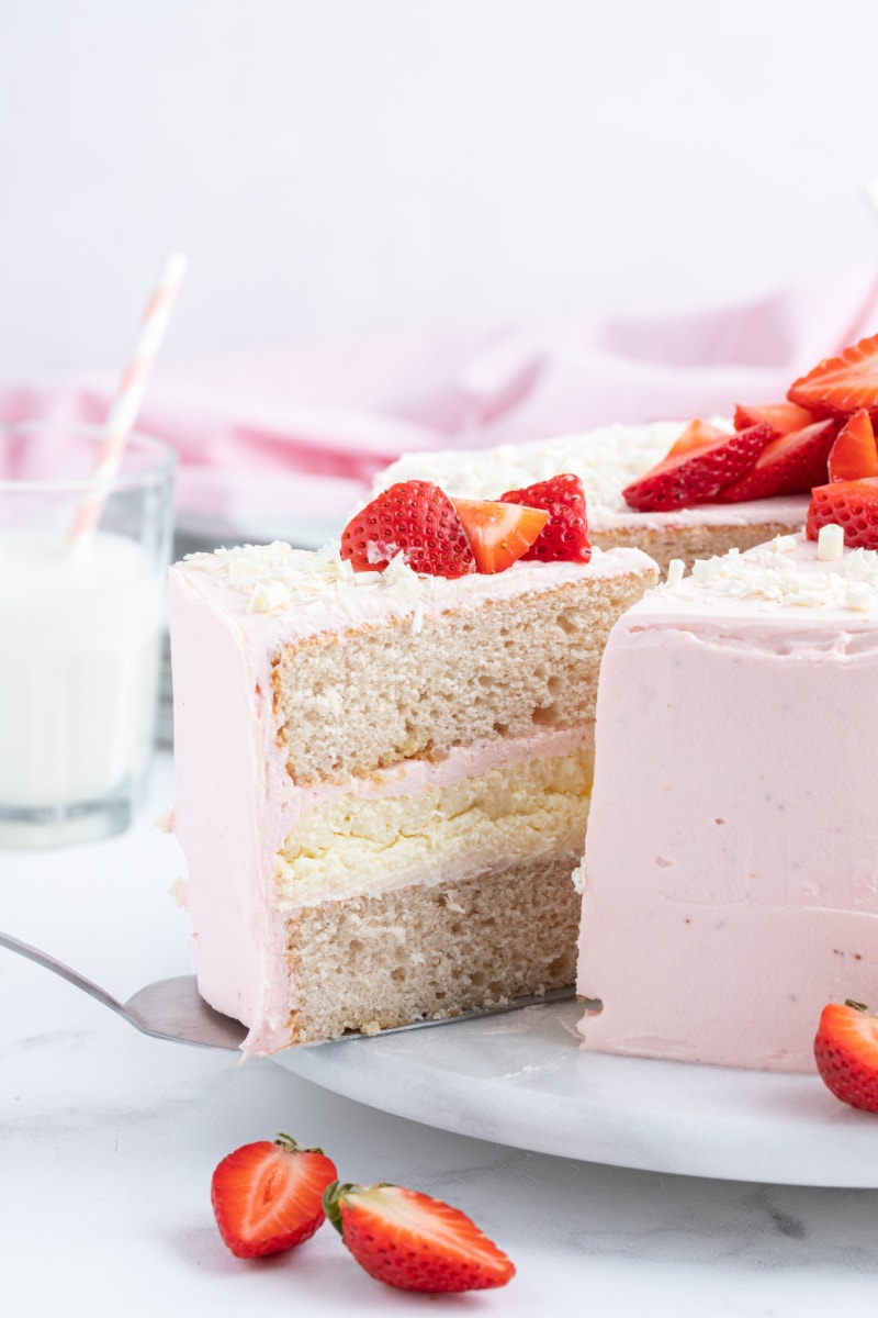 taking a slice out of strawberry cheesecake cake