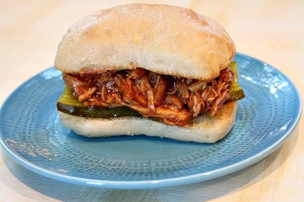 Slow Cooker Pulled Barbecued Chicken Sandwiches recipe from RecipeGirl.com #slow #cooker #slowcooker #crockpot #pulled #bbq #barbecue #barbecued #chicken #sandwiches #recipe #RecipeGirl Pulled Barbecued Chicken Sandwiches on a blue plate