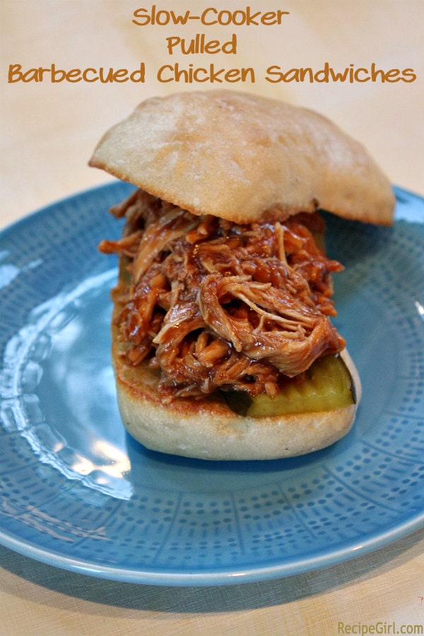 Slow Cooker Pulled Barbecued Chicken Sandwiches recipe from RecipeGirl.com #slow #cooker #slowcooker #crockpot #pulled #bbq #barbecue #barbecued #chicken #sandwiches #recipe #RecipeGirl Pulled Barbecued Chicken Sandwiches on a blue plate