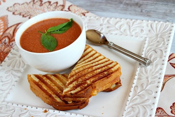 10 Minute Tomato Soup in a white bowl with a grilled cheese sandwich