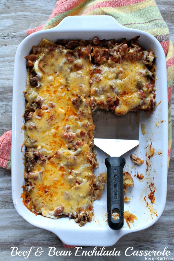 Beef and Bean Enchilada Casserole recipe from RecipeGirl.com #beef #bean #enchilada #casserole #recipe #recipegirl #easy #weeknight #dinner Beef and Bean Enchilada Casserole in a white baking dish