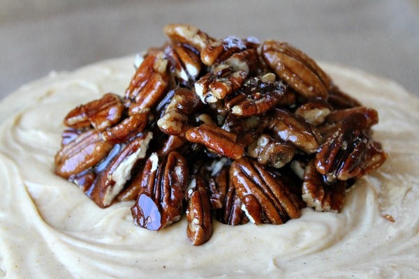 candied pecans on top of a cake