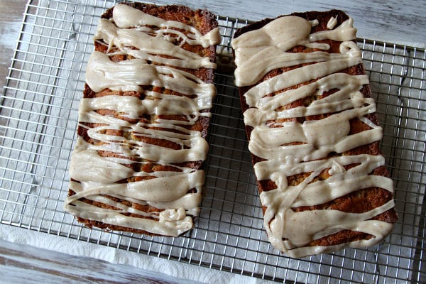 two loaves of spiced pear cake on a baking rack
