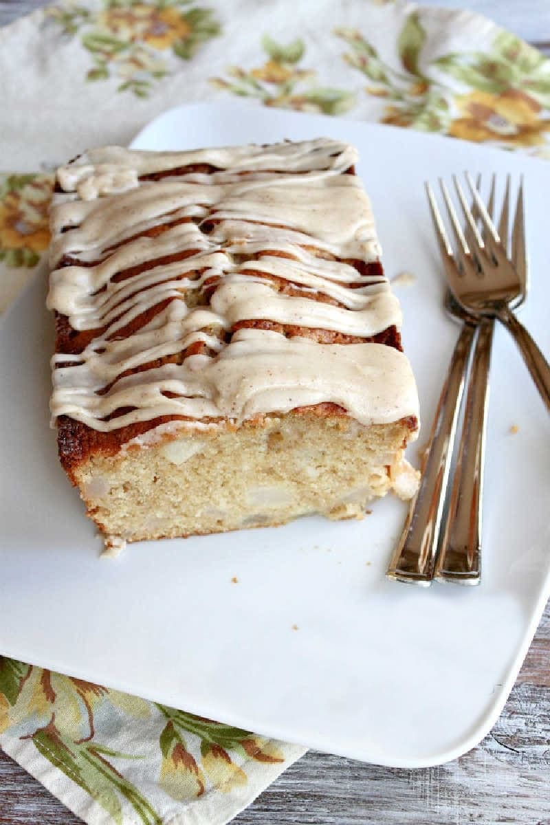 spiced pear cake on serving plate cut open to see inside