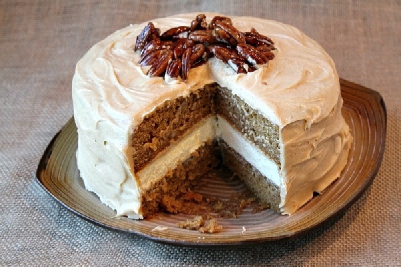 pumpkin cheesecake cake with a slice taken out of it