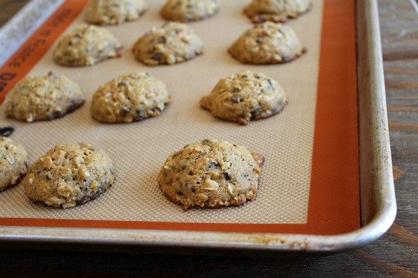 Pumpkin Oatmeal Candy Bar Cookies recipe from RecipeGirl.com #pumpkin #oatmeal #candy #candybar #chocolate #cookies #recipe #RecipeGirl cookies on a baking sheet
