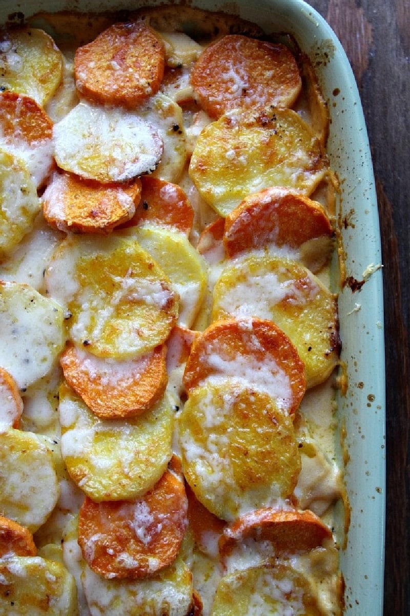 Pumpkin Scalloped Potatoes recipe from RecipeGirl.com #pumpkin #scalloped #potatoes #recipe #RecipeGirl pumpkin scalloped potatoes in a casserole dish