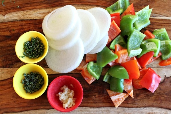 Sausage and Potato Bake recipe from RecipeGirl.com veggies and herbs displayed