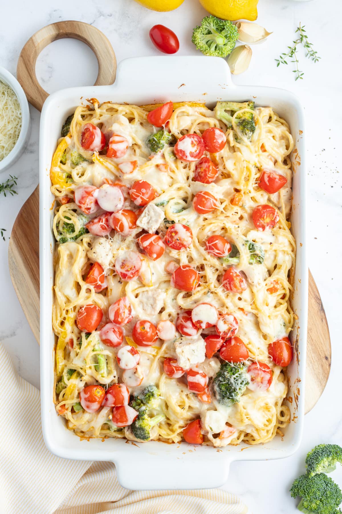 baked lemon chicken spaghetti primavera in a baking dish