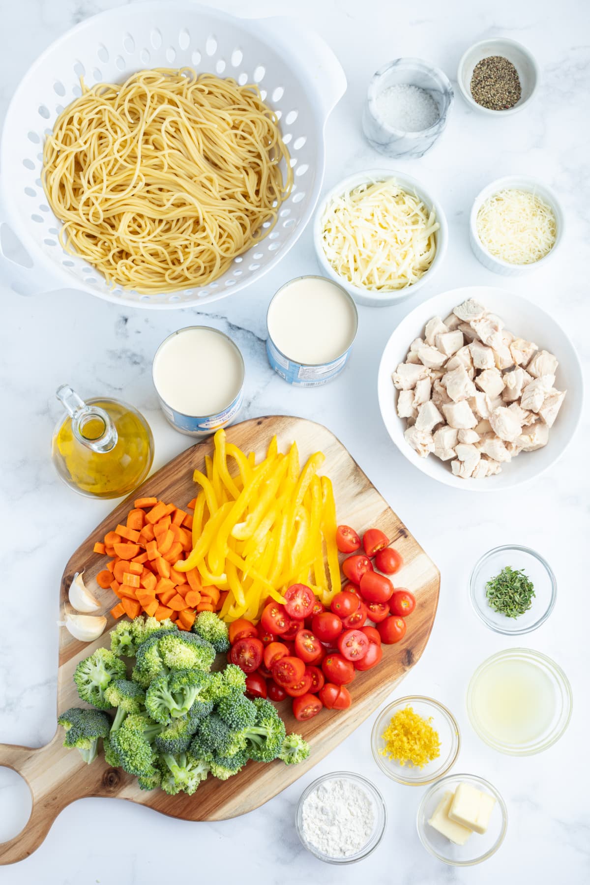 ingredients displayed for making baked lemon chicken spaghetti primavera