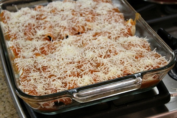 vegetable enchiladas in a baking pan ready to go in the oven