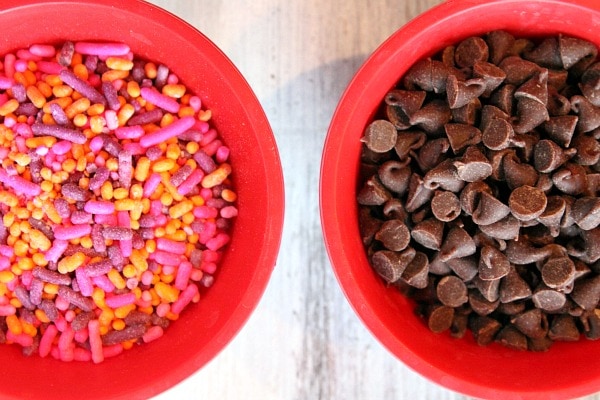 sprinkles and chocolate chips in red bowls